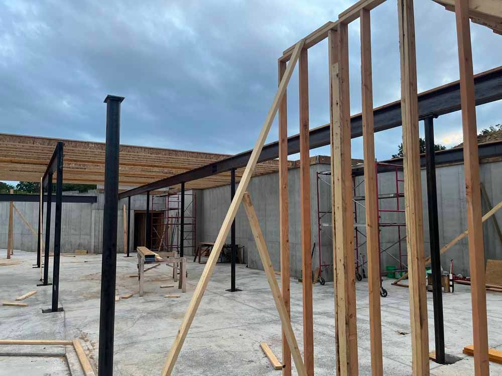 A building under construction with wooden beams and scaffolding.