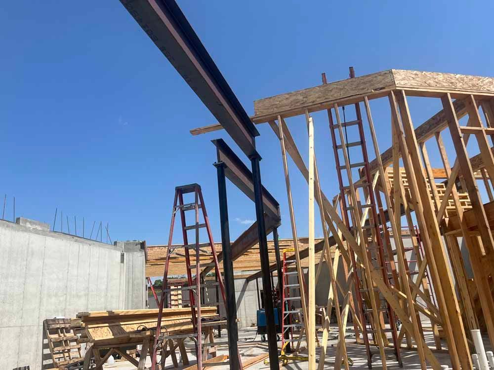 A building under construction with a blue sky in the background.