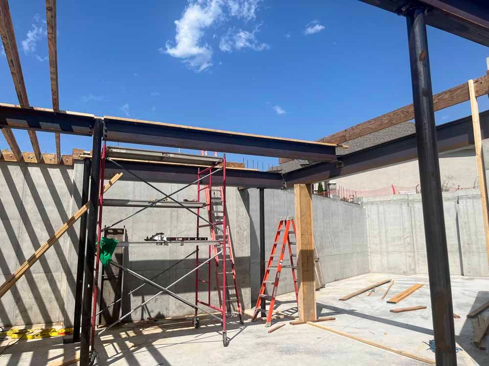 A construction site with a scaffolding and a ladder.