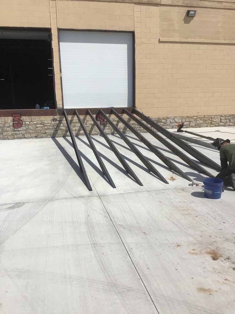 A man is working on a ramp in front of a building.