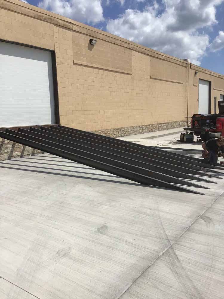 A large ramp is sitting in front of a building.