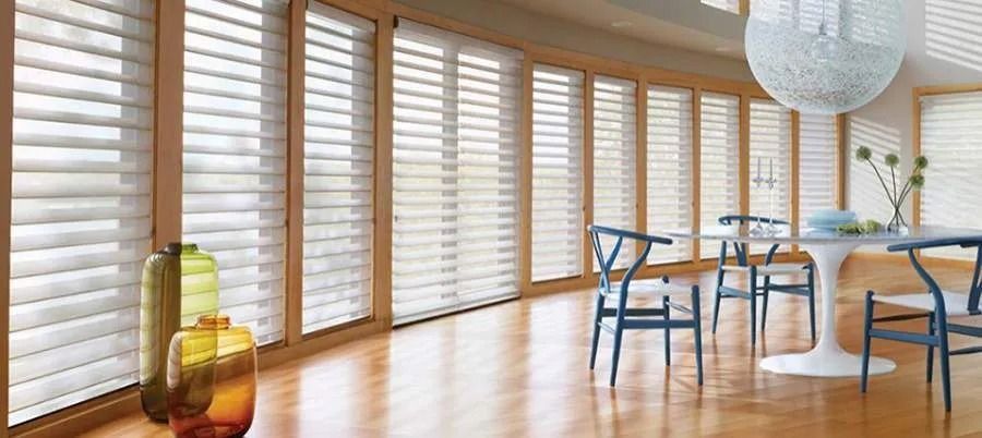 Close-up of horizontal window blinds with light and shadow in a long corridor