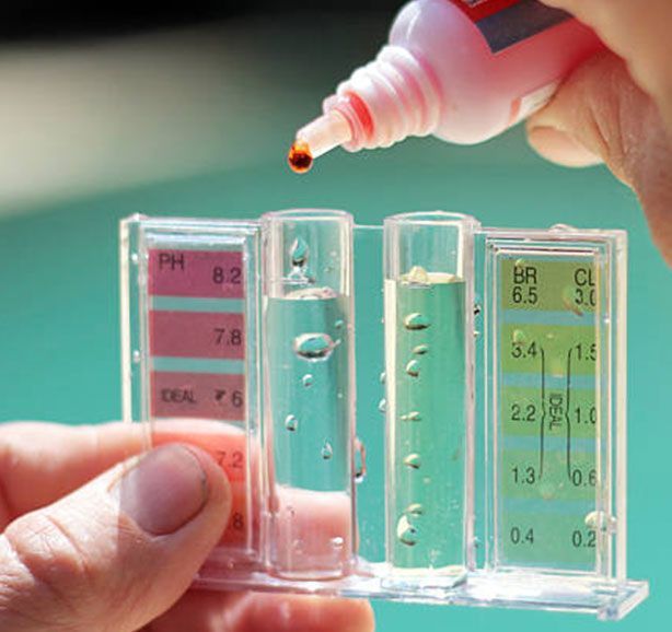 A person is pouring liquid into a test tube