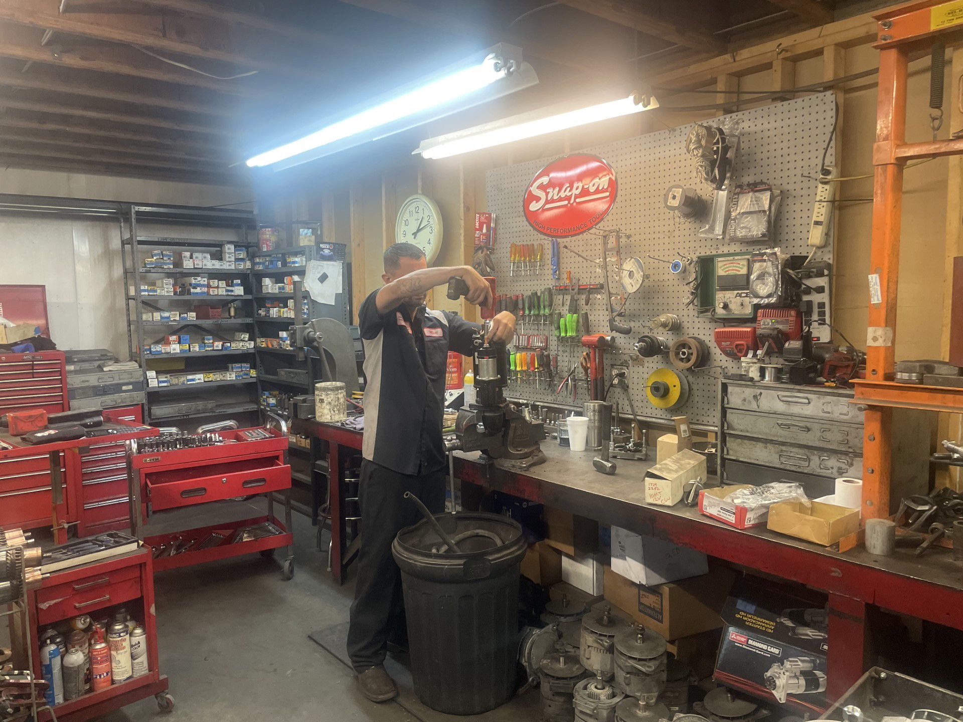 A man is working on a machine in a garage.