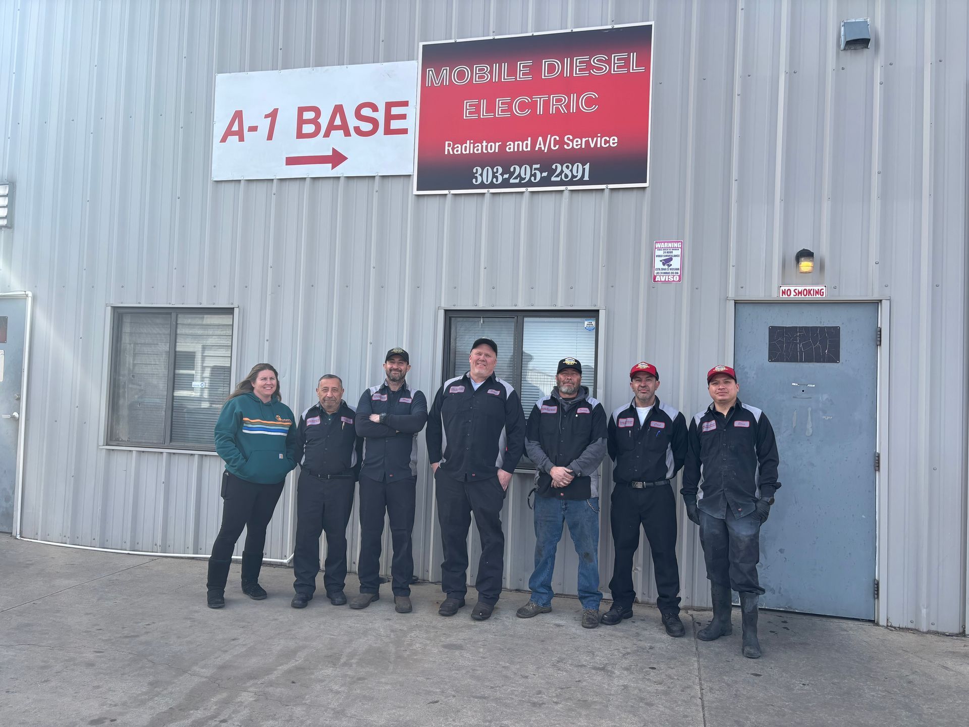 A group of men are standing in front of a building.