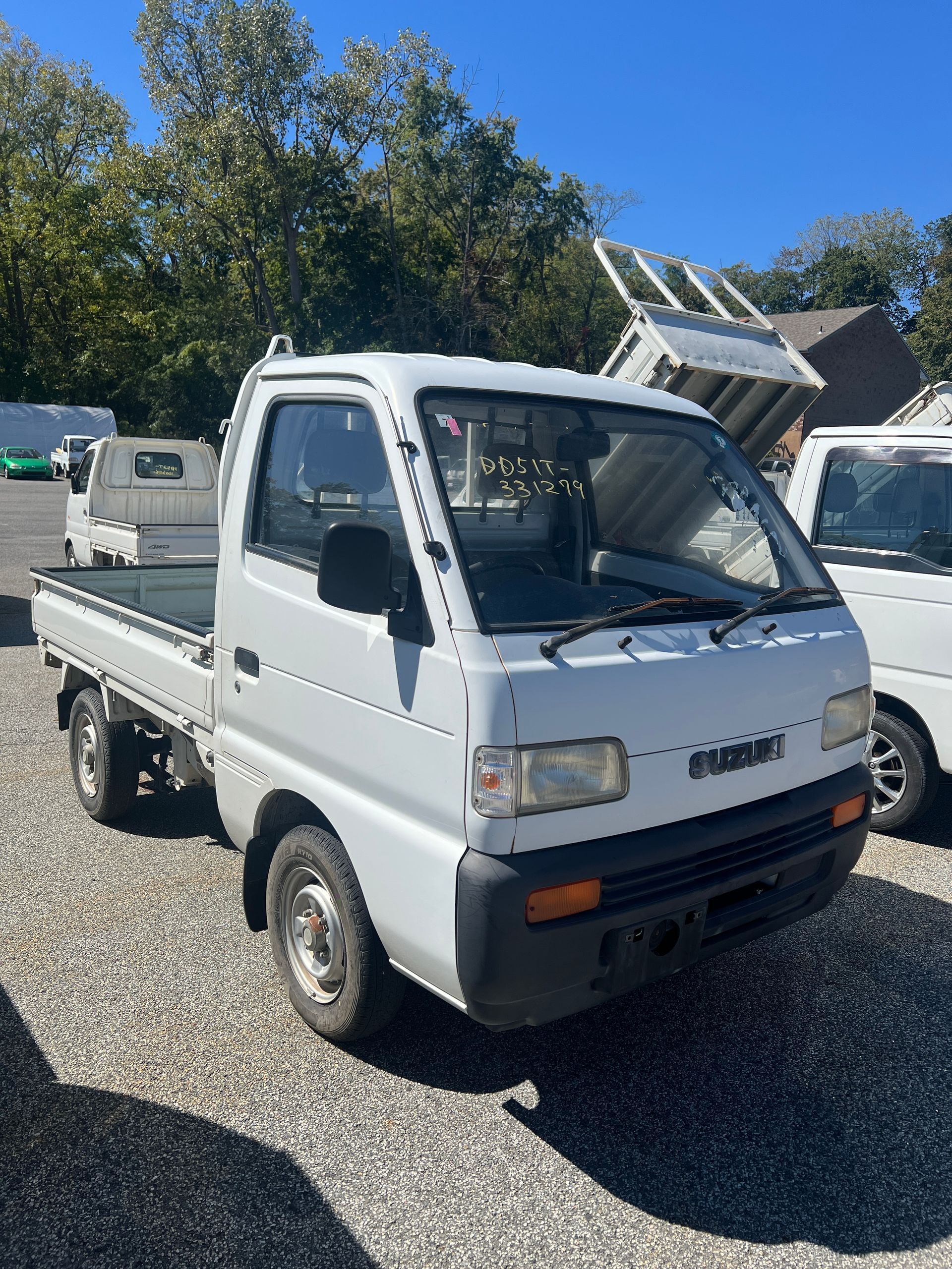 A kei truck for sale suzuki Carry for sale in a parking lot
