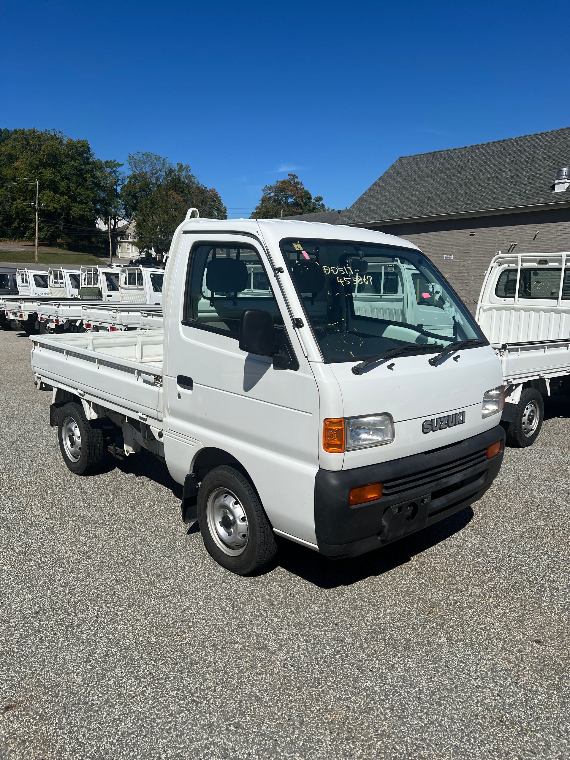 A kei truck for sale suzuki Carry for sale in a parking lot
