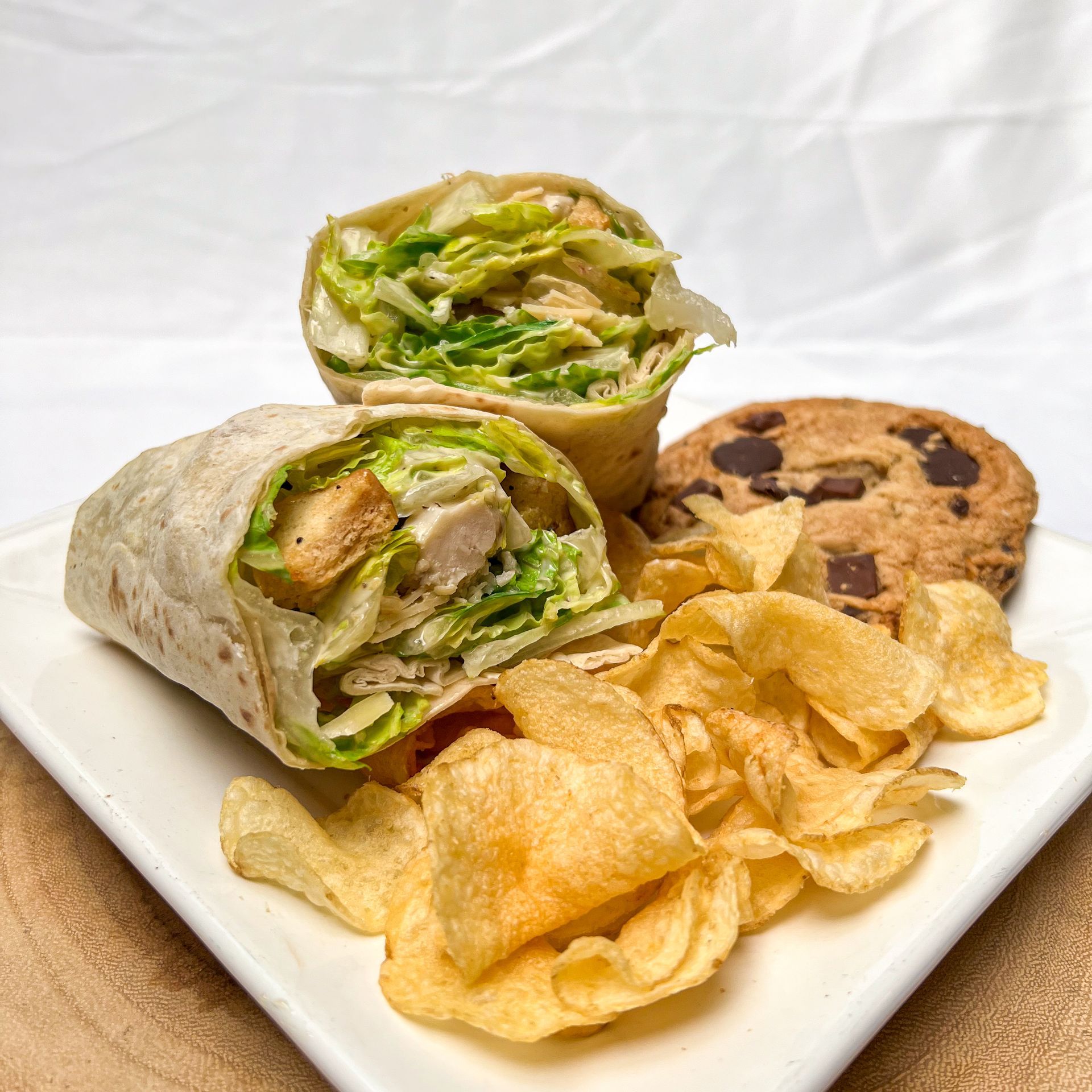 Boxed lunches Seattle. Chicken Caesar wrap with chips and a cookie. 