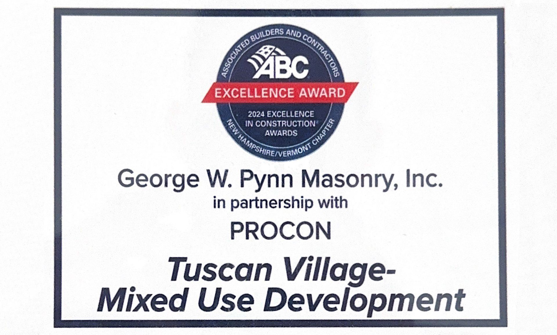 A plaque that says tuscan village mixed use development