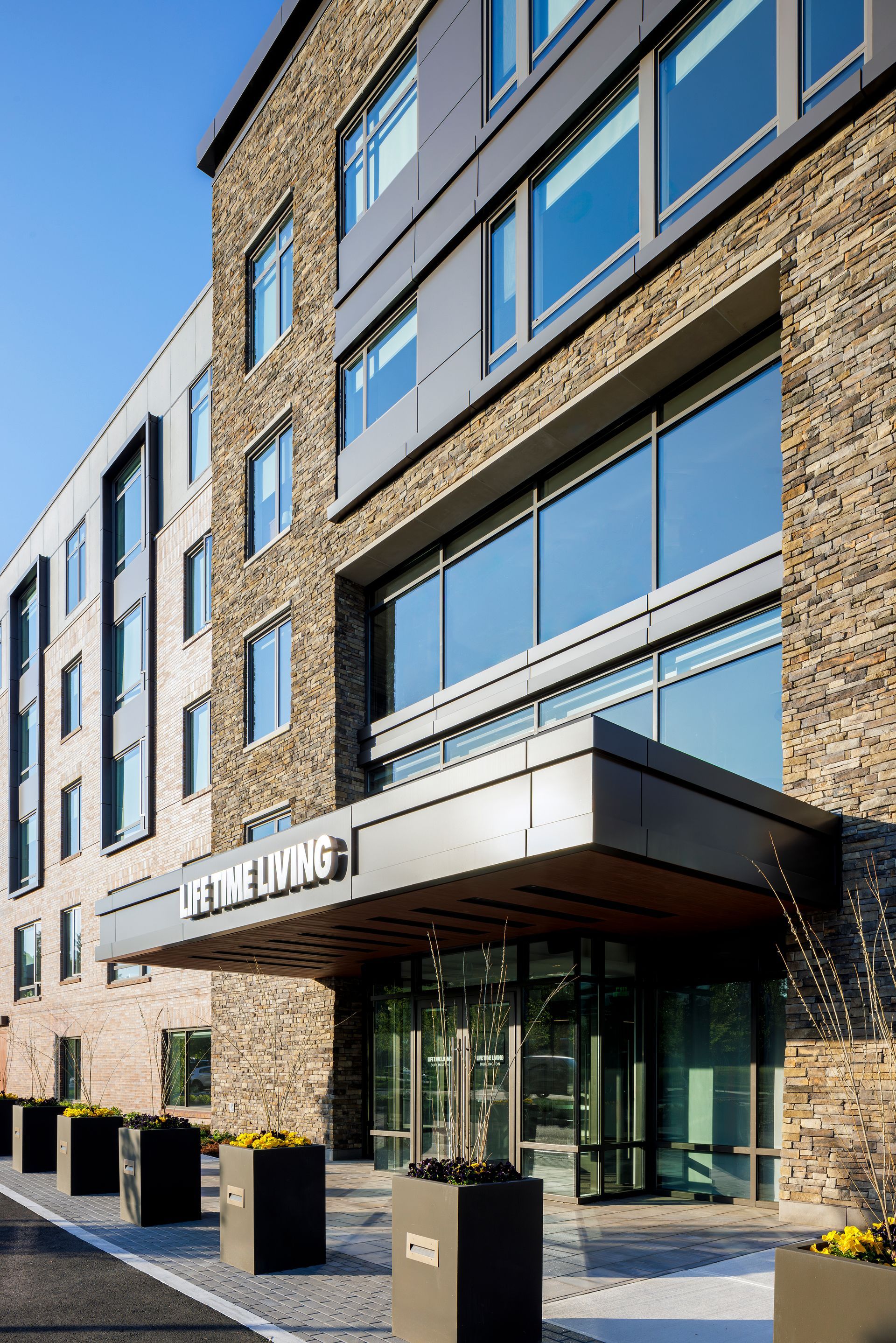 The entrance to a large building with a lot of windows