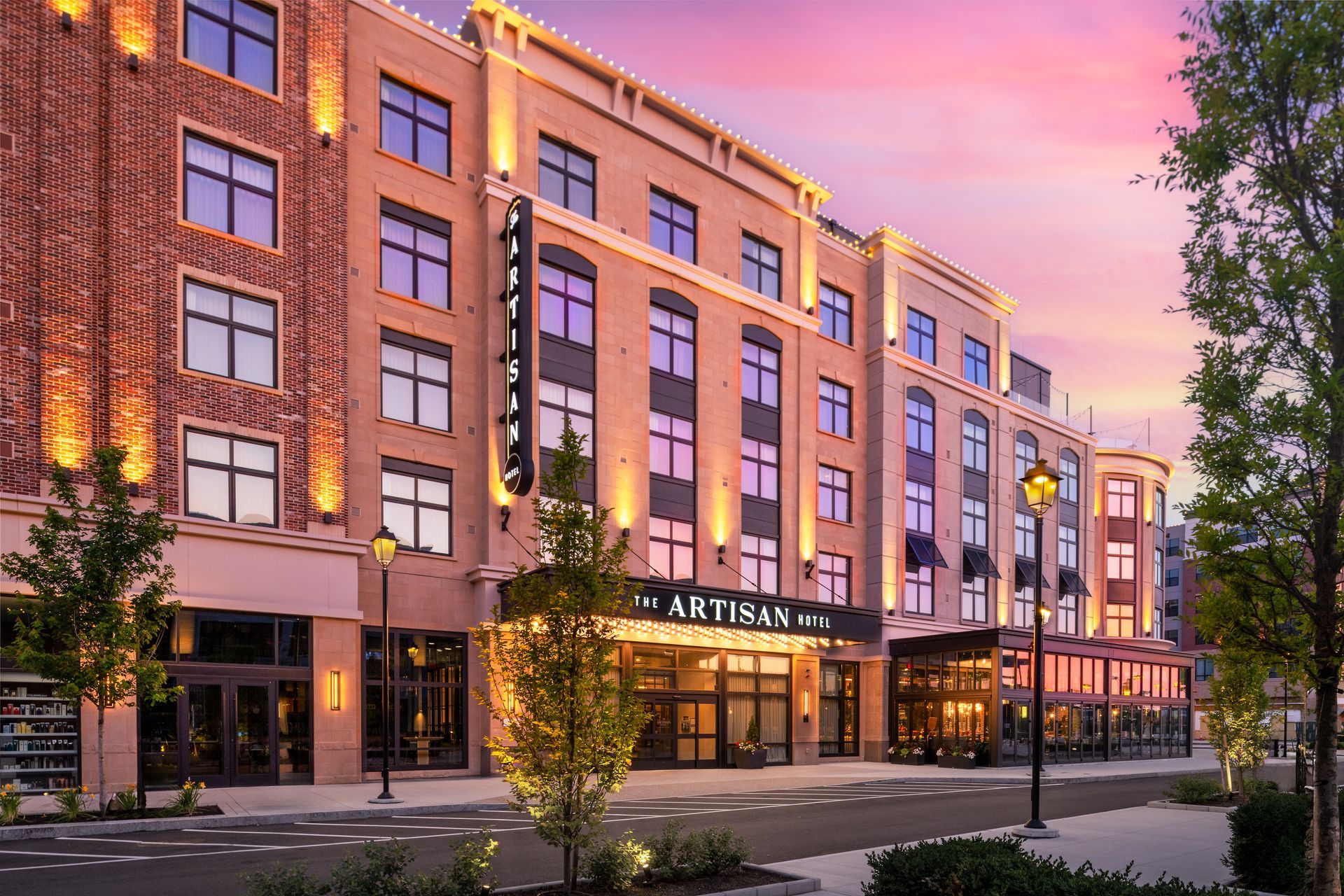 A large building with a lot of windows is lit up at night.