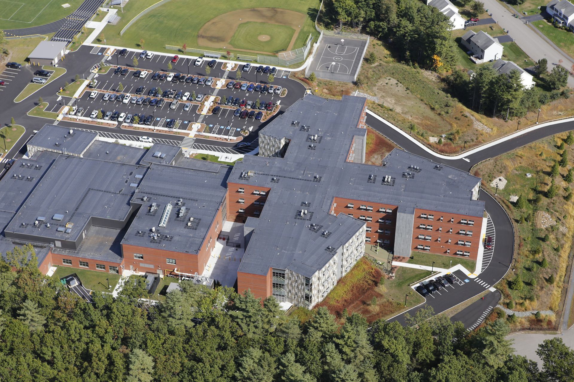 An aerial view of a large building surrounded by trees.