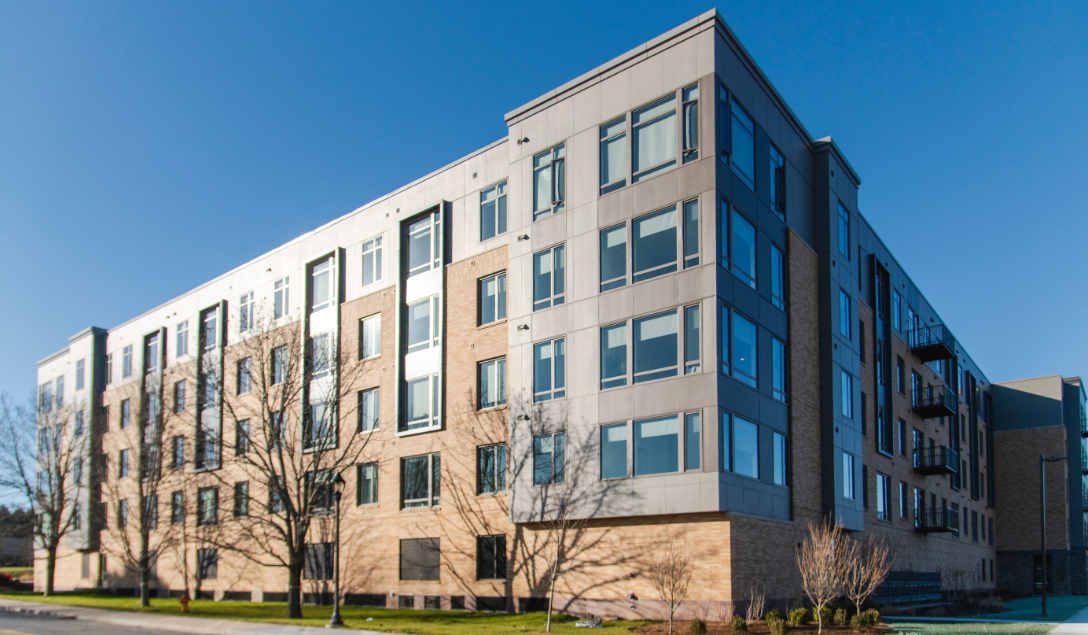 A large building with a lot of windows on a sunny day.