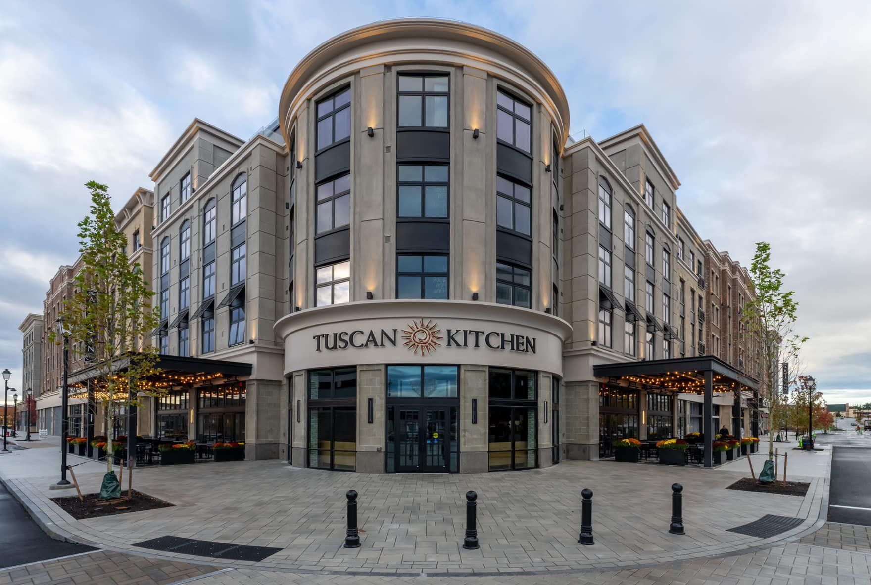 A large building with a lot of windows and a sign that says tuscan kitchen