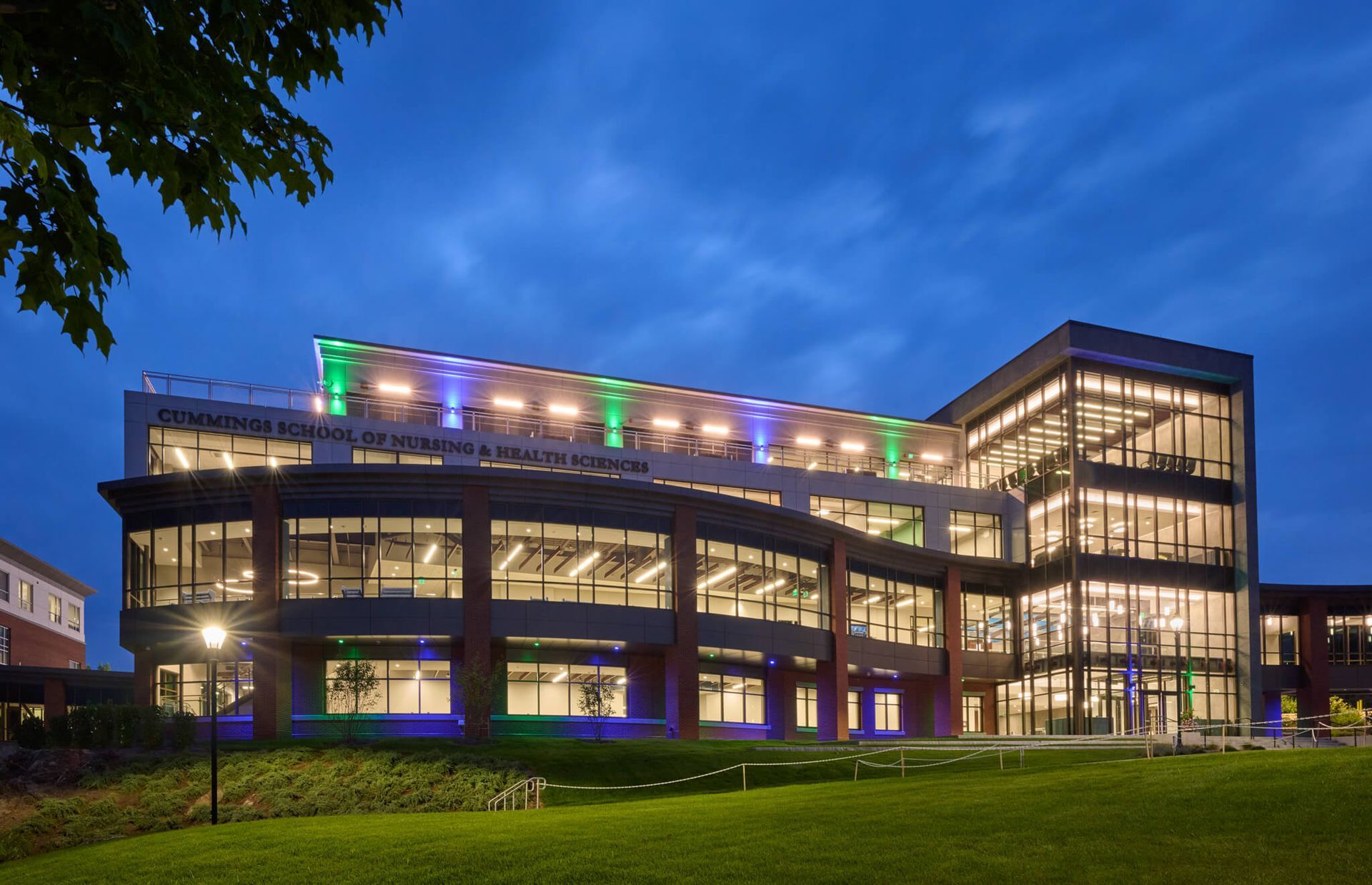 A large building with lots of windows is lit up at night
