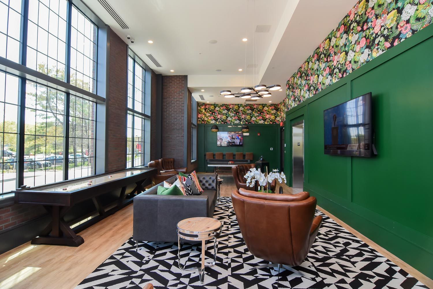 A living room with a couch, chair, table and television.