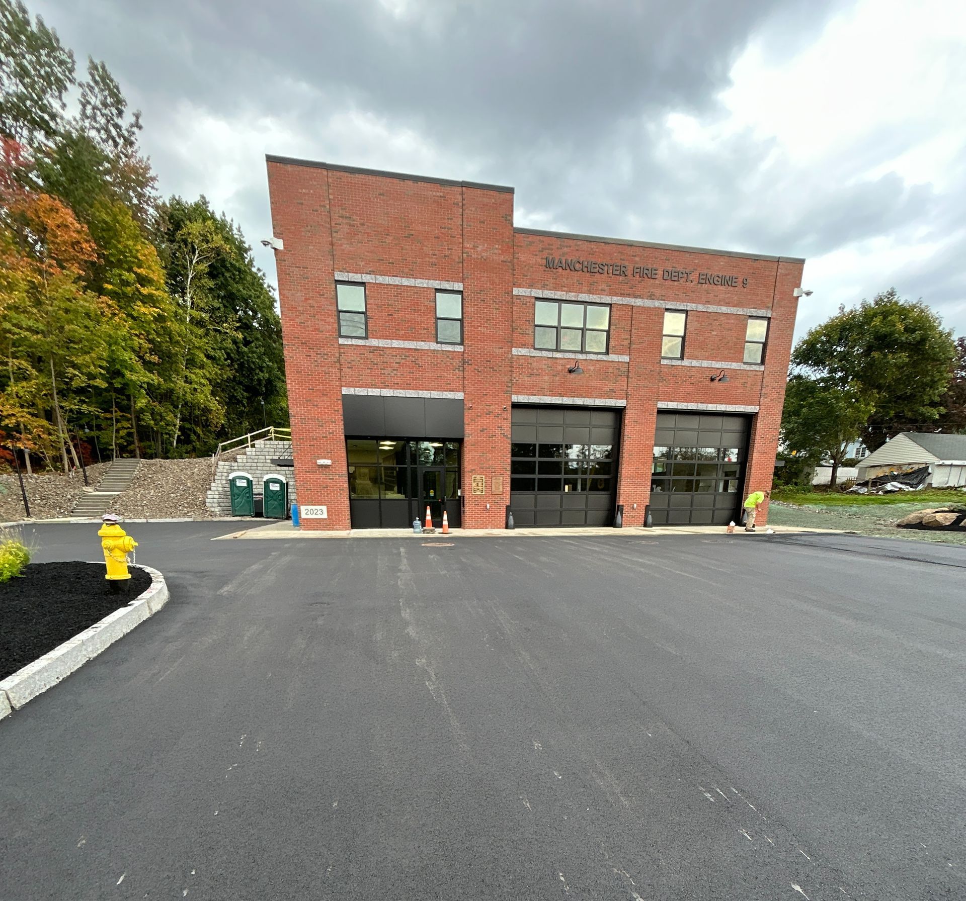 A large brick building with a parking lot in front of it.