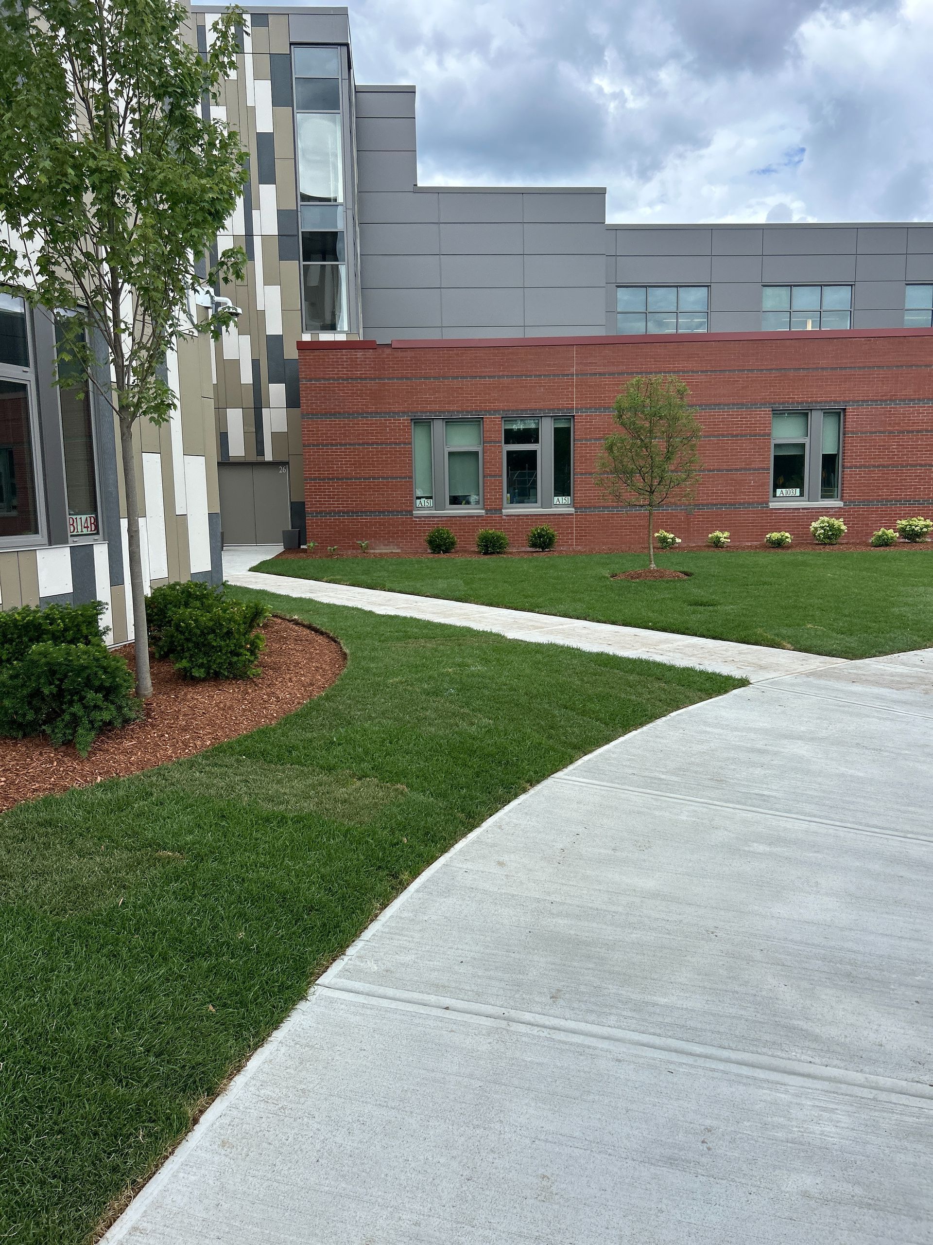 A brick building with a concrete walkway leading to it