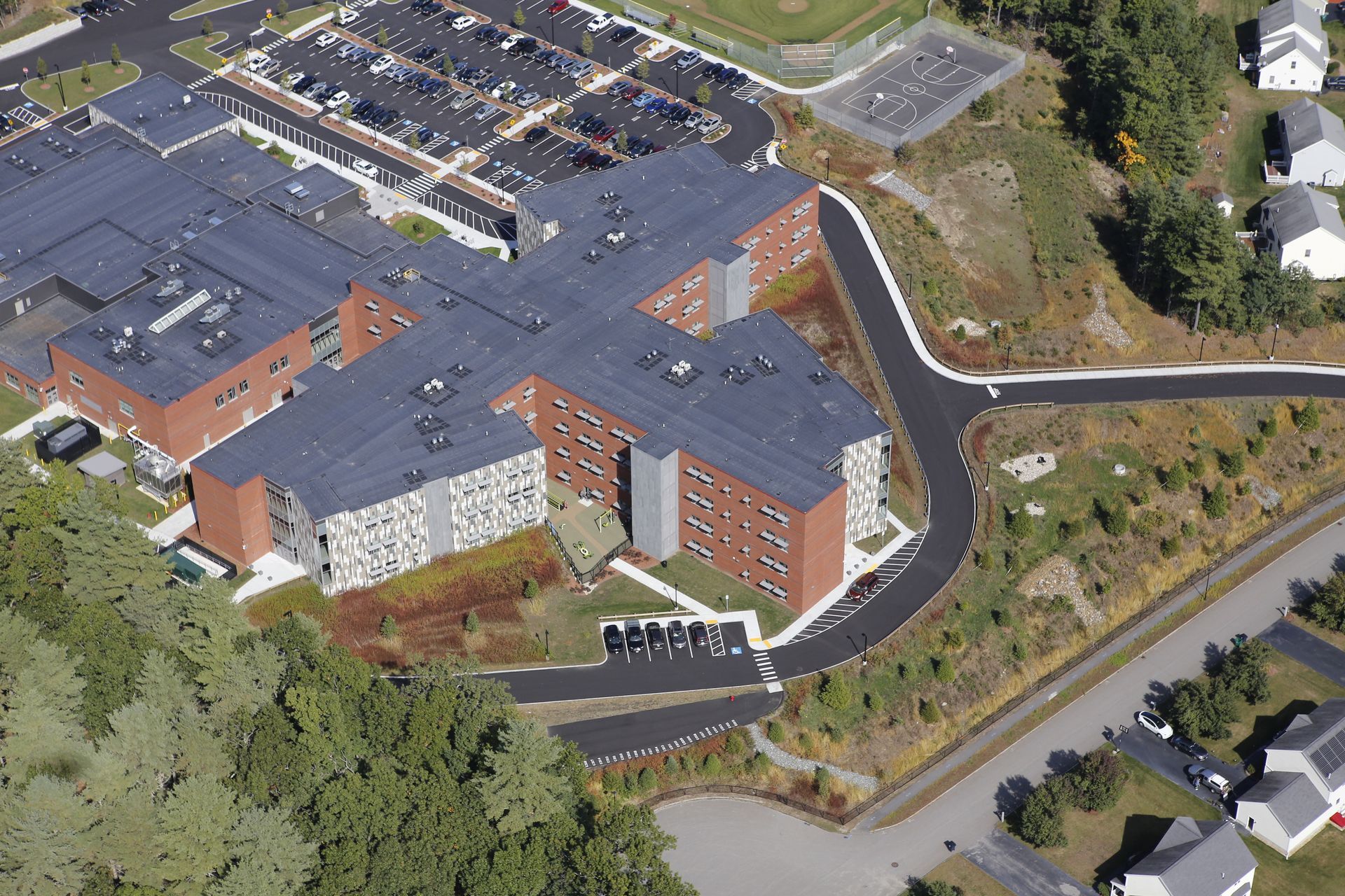 An aerial view of a large building surrounded by trees