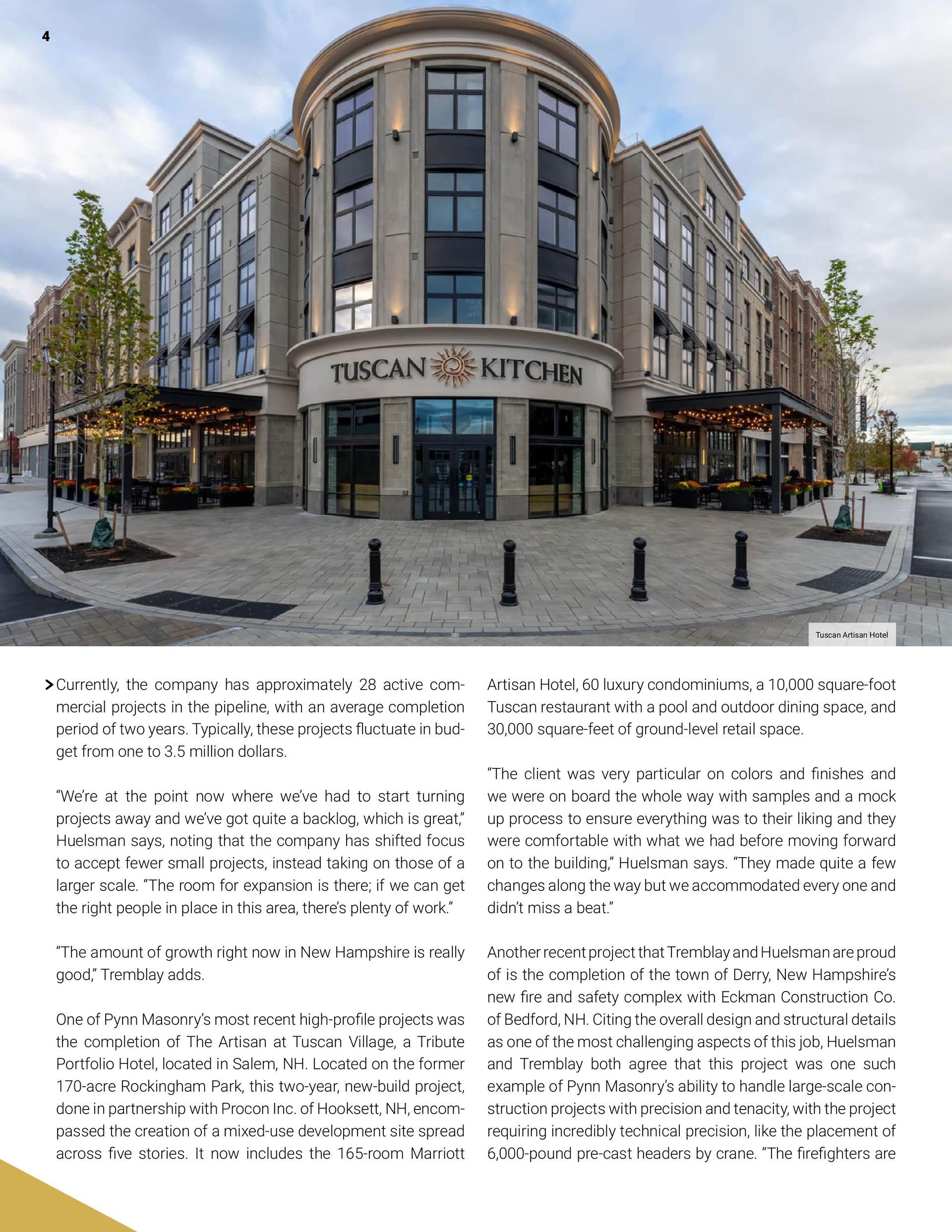 Exterior of Tuscan Kitchen restaurant. Gray building with arched entrance. Outdoor seating.