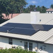 A house with a lot of solar panels on the roof.