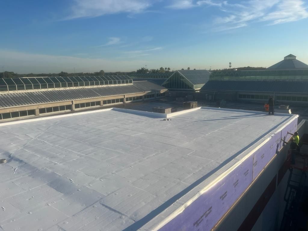 A large white roof with a blue sky in the background