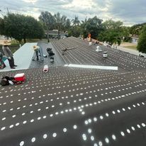 A group of people are working on a roof.