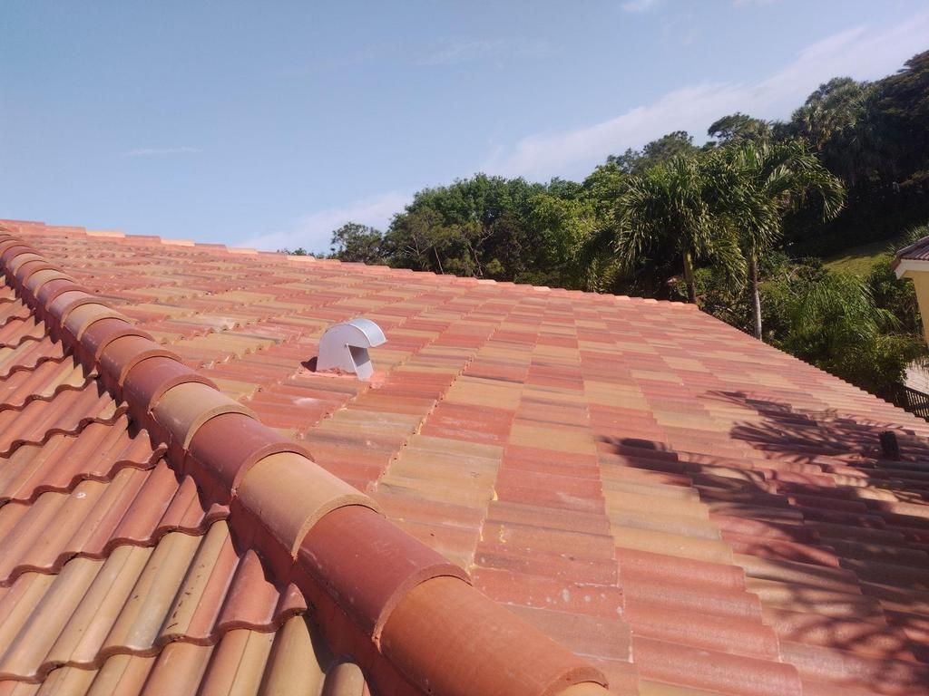 A person is standing on the roof of a house.