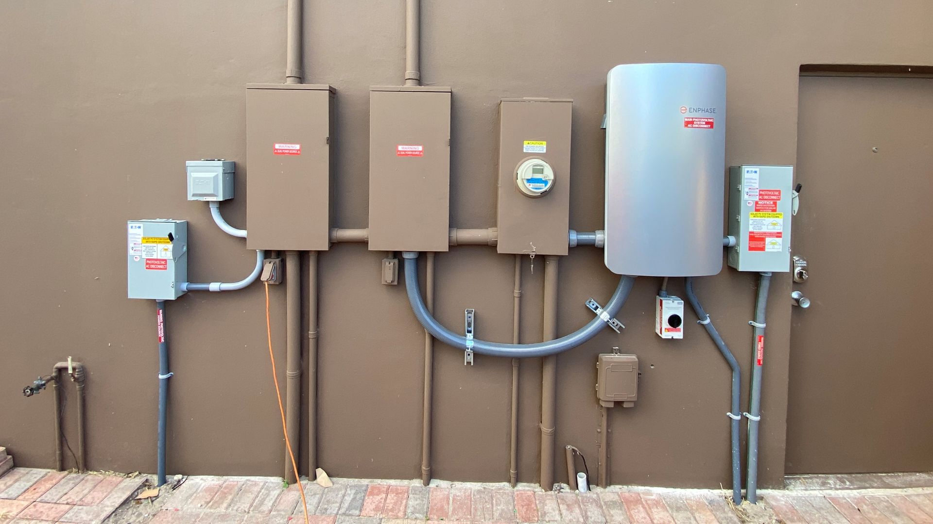 A wall with a bunch of electrical boxes on it
