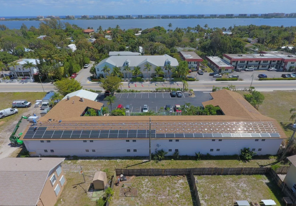 An aerial view of a building with solar panels