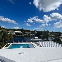 A view of a swimming pool from the roof of a house.