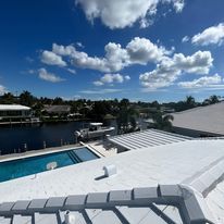 A view of a swimming pool from the roof of a house.
