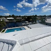 A view of a swimming pool from the roof of a house.