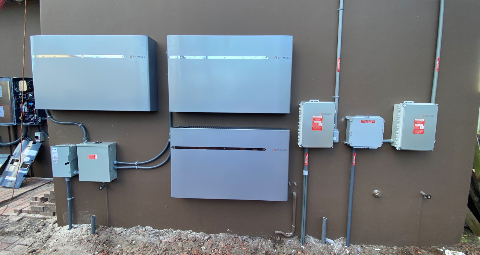 A wall with a lot of electrical boxes on it