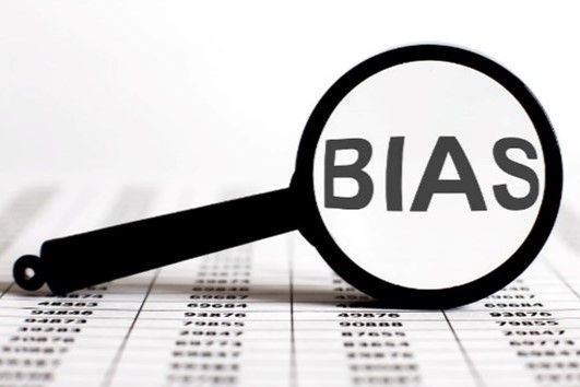 An image of a magnifying glass with the word BIAS magnified