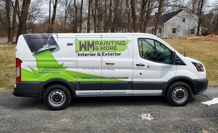 A white van is parked on the side of the road.