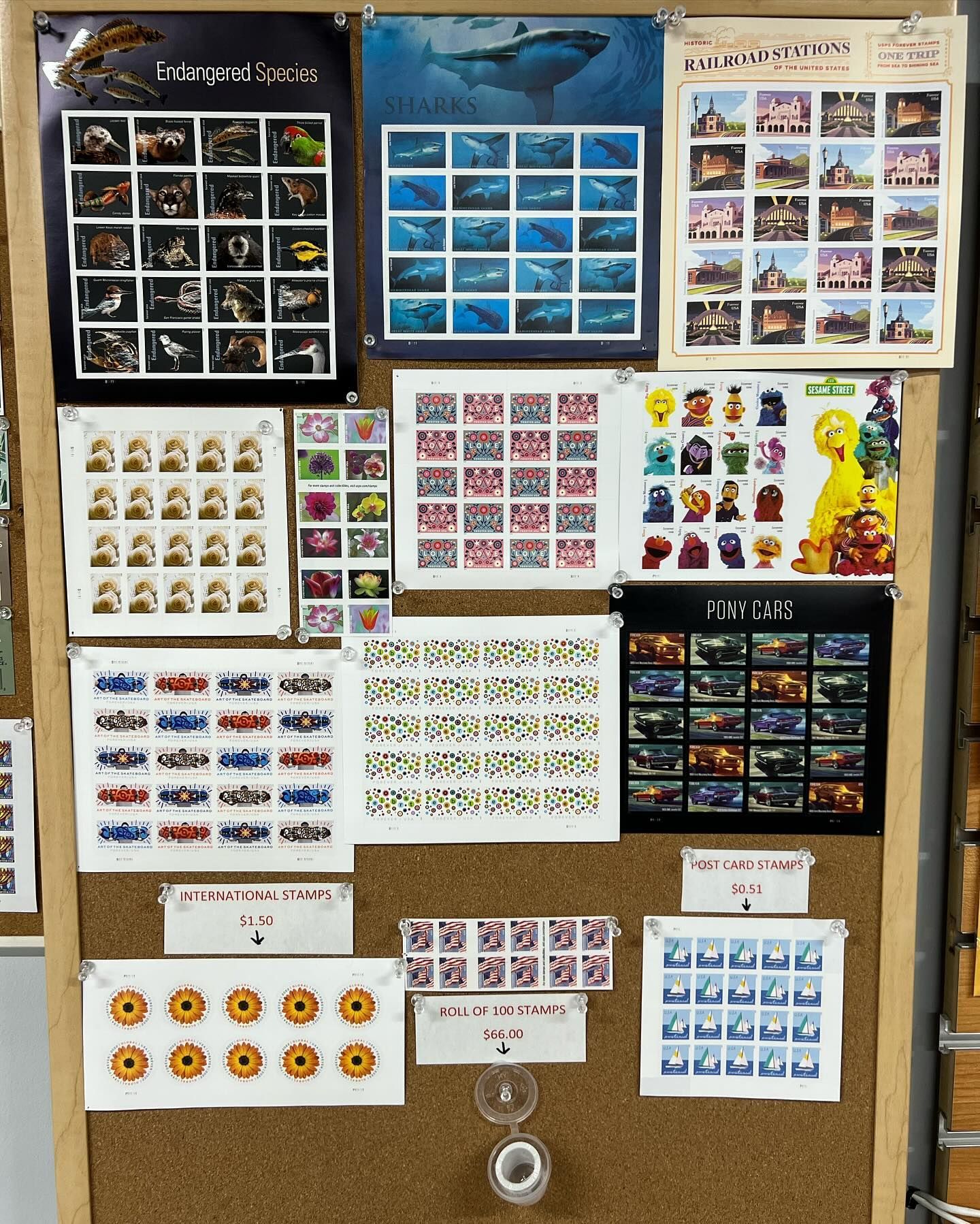 A corkboard displays collections of postage stamps featuring varied themes, including nature, space, and Sesame Street.