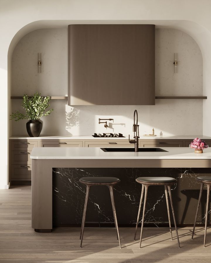 Modern kitchen with island, marble accents, and archway. Neutral tones, dark range hood, and stools.