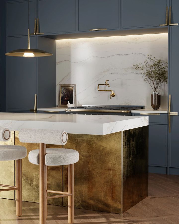 Modern kitchen with gold island, blue cabinets, marble backsplash, and gold fixtures.