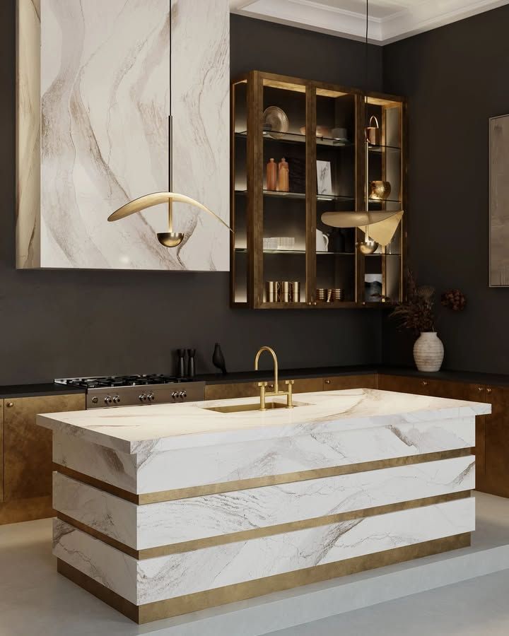 Luxurious kitchen with marble island, gold accents, and a modern pendant light. Dark gray walls and cabinetry.