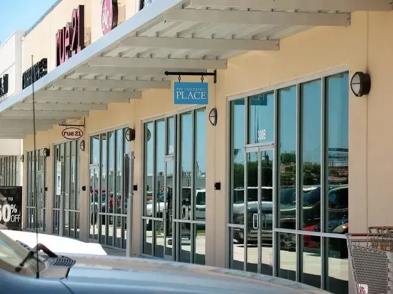 A row of storefronts in a strip mall, featuring 
