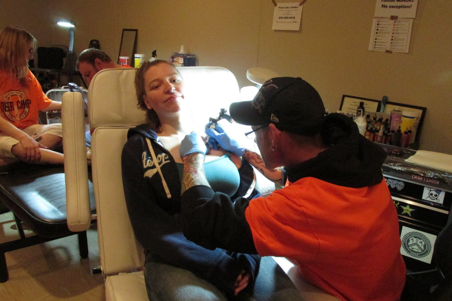 Woman having a tattoo at her chest