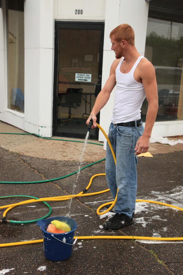 Man holding a hose with water