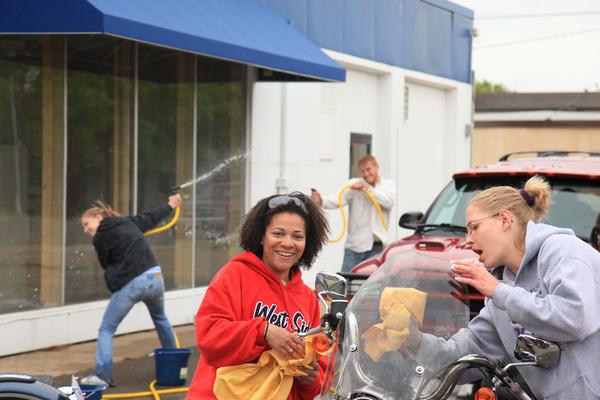 Two woman wiping motorcycle