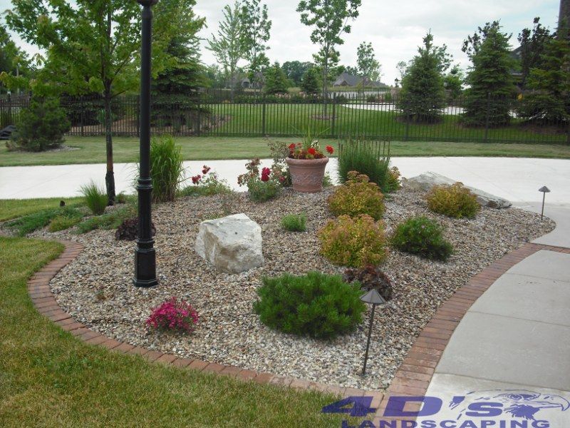 A landscape with a sign that says 4d 's landscaping