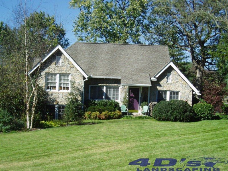 A house with a 4d 's landscaping logo on it