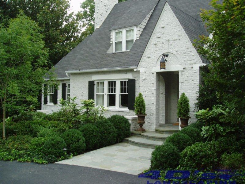 A white house with a black roof and black shutters