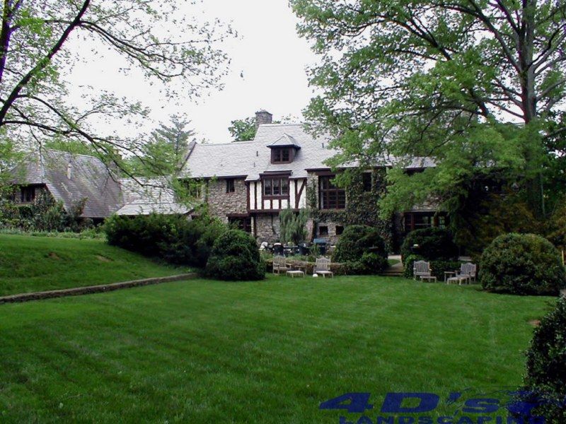 A large house with a large lawn in front of it