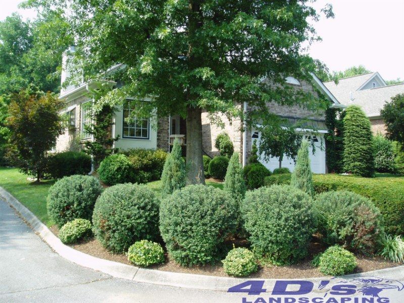 A 4d 's landscaping logo is on the side of a house