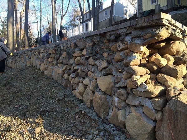 A large pile of rocks is sitting on top of a dirt hill.